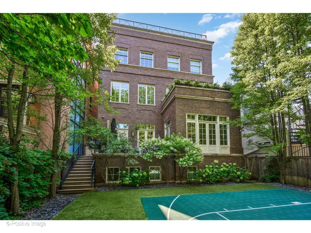 a bedroom with bed and a large window
