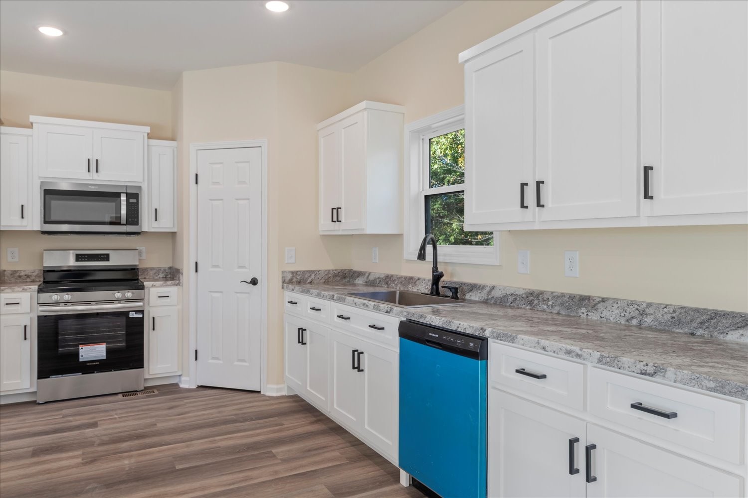 975 Weakley Creek Road Lawrenceburg, TN 38464 - Photo 12 of 49 a kitchen with granite countertop a stove top oven sink and cabinets