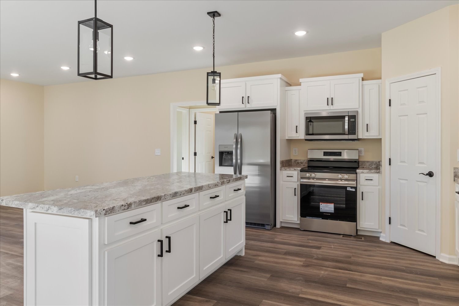 975 Weakley Creek Road Lawrenceburg, TN 38464 - Photo 13 of 49 a kitchen with stainless steel appliances a stove refrigerator sink and microwave