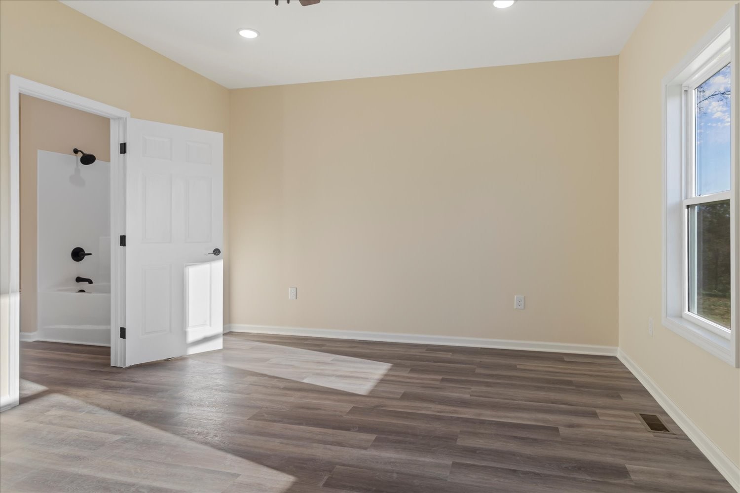 975 Weakley Creek Road Lawrenceburg, TN 38464 - Photo 16 of 49 a view of an empty room with wooden floor and a window