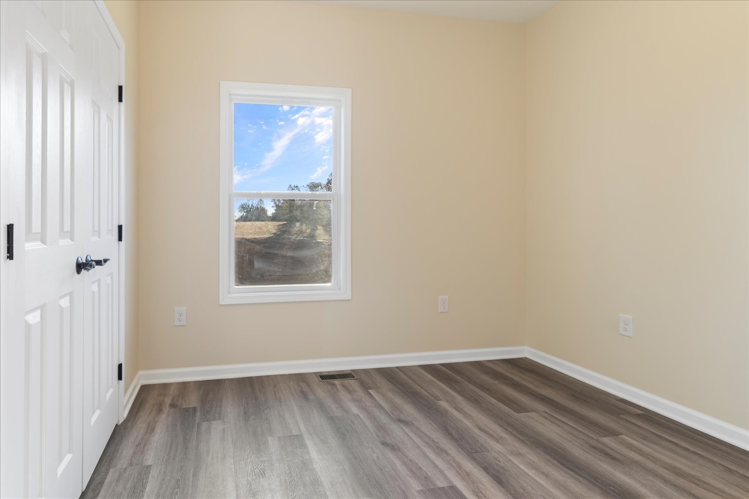 975 Weakley Creek Road Lawrenceburg, TN 38464 - Photo 21 of 49 a view of an empty room with wooden floor and a window