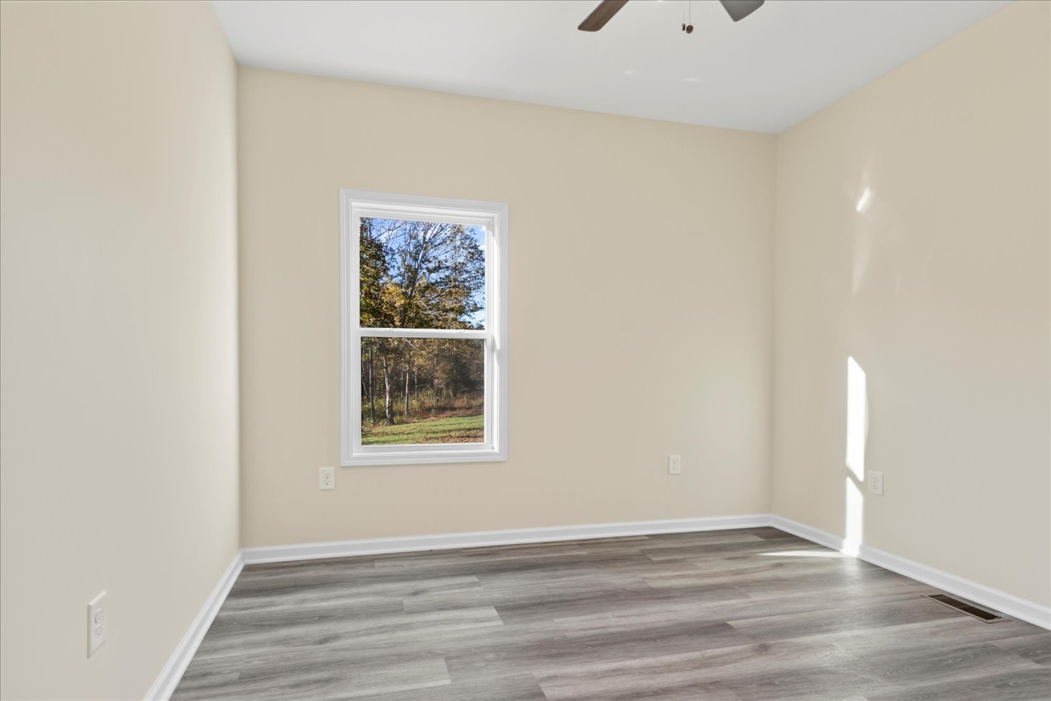 975 Weakley Creek Road Lawrenceburg, TN 38464 - Photo 23 of 49 a view of an empty room with wooden floor and a window