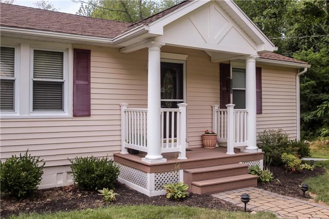 a front view of a house with plants