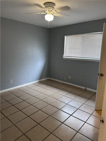 a bathroom with a granite countertop toilet and a sink
