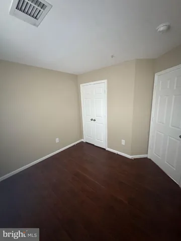 an empty room with wooden floor