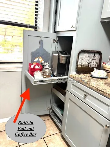 a kitchen with a stove and a white cabinet