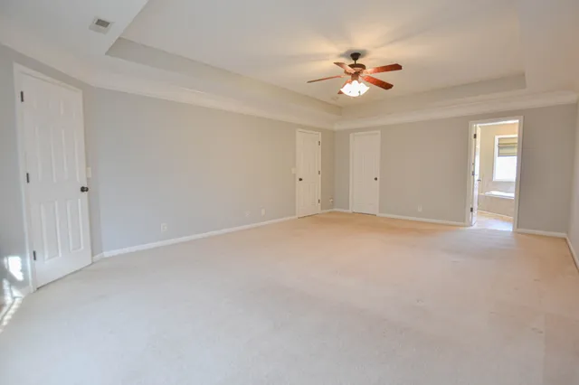 a view of a livingroom with a ceiling fan and window