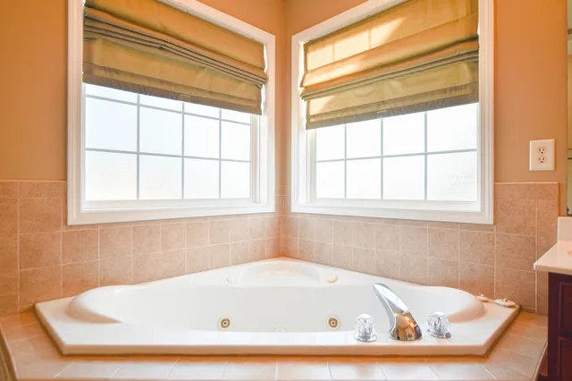 a bathroom with bathtub and window