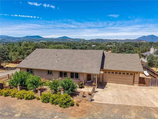 an aerial view of multiple houses with a yard