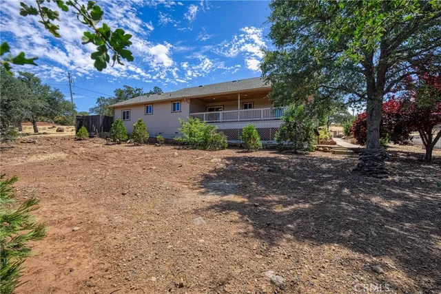 an aerial view of residential houses with outdoor space and ocean view