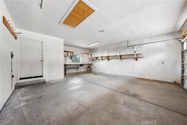 a kitchen with stainless steel appliances granite countertop a refrigerator a stove and a sink