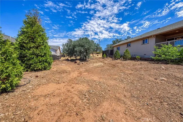 a view of an empty room with window and cabinet