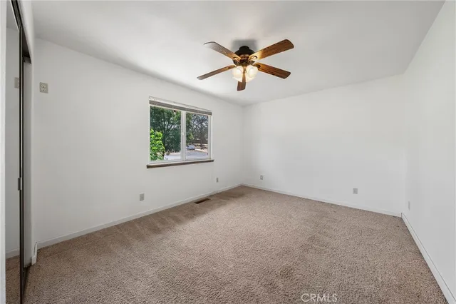 a front view of a house with a tree