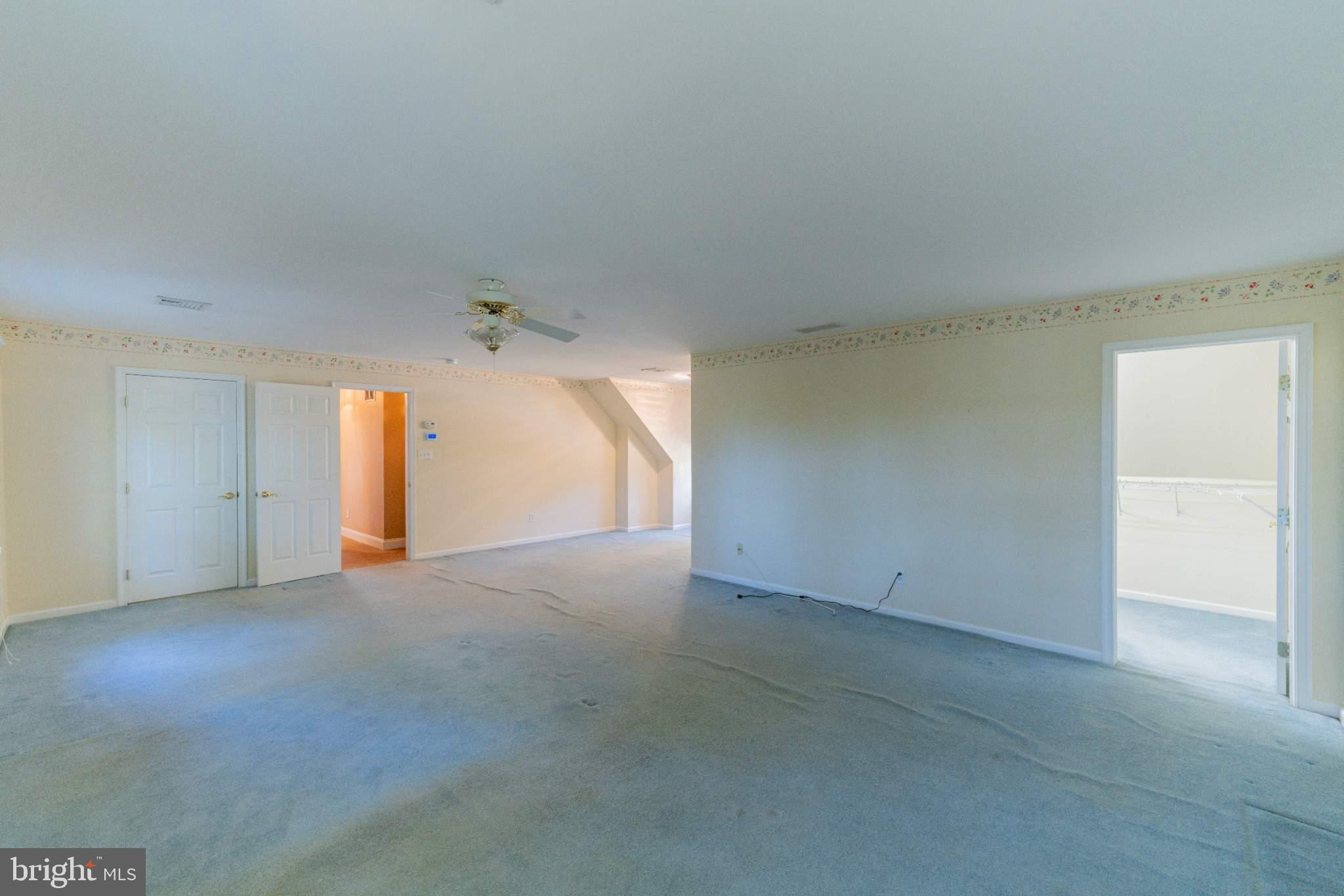 404 Langford Road Broomall, PA 19008 - Photo 22 of 40 an empty room with a ceiling fan and a window