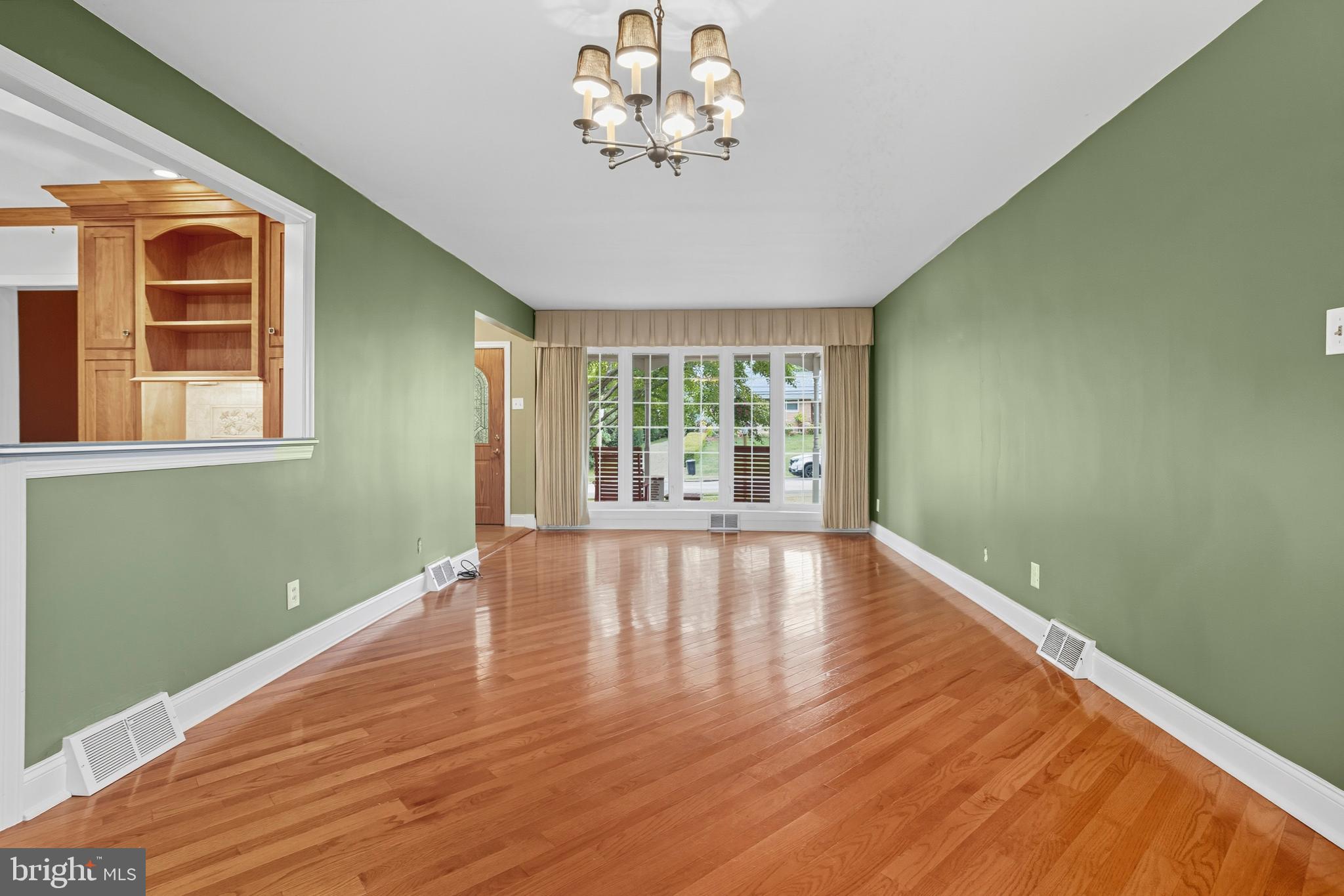 404 Langford Road Broomall, PA 19008 - Photo 7 of 40 a view of an empty room with wooden floor and a window