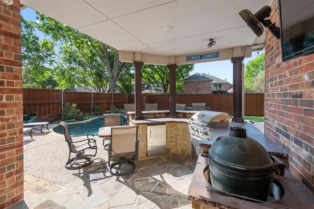 a patio with patio fireplace and outdoor seating