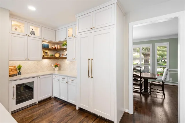 a kitchen with cabinets and wooden floor