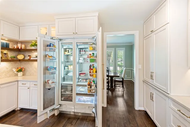 a view of a hallway with wooden floor and windows