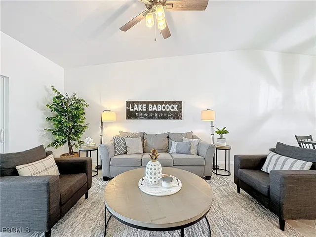 a living room with furniture and a potted plant