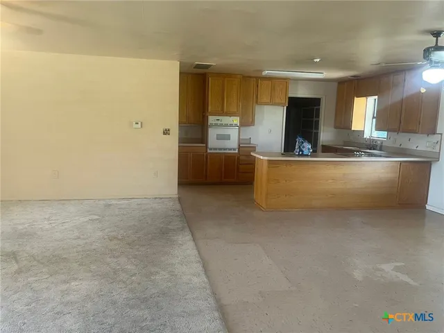 a kitchen with a sink stove and cabinets