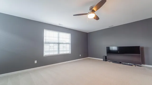 a workspace with a flat screen tv and window