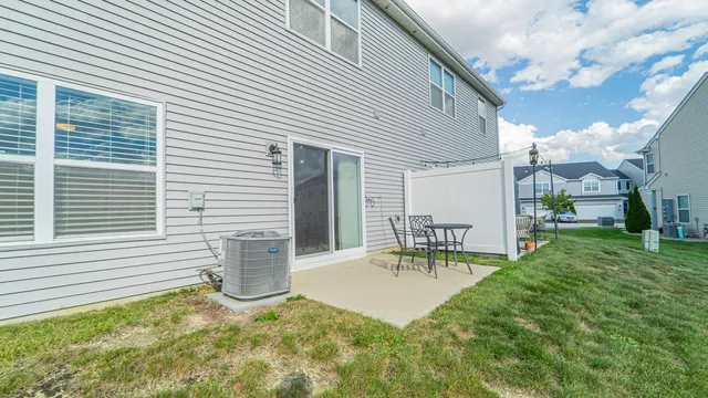 a view of a patio with table and chairs and potted plants