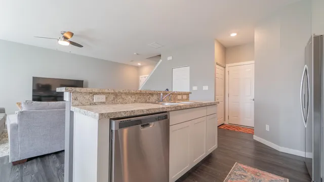 a bathroom with a granite countertop sink a mirror and a shower