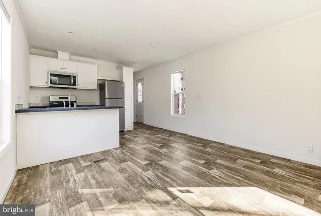 a view of a kitchen with microwave and cabinets