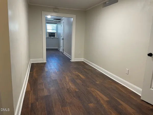 a view of a room with wooden floor