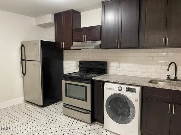 a kitchen with a sink and a refrigerator