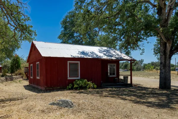 a view of a house with a tree in front of it
