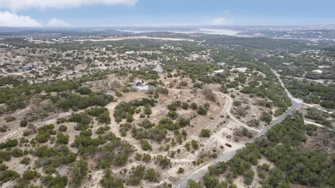 an aerial view of residential houses with city view