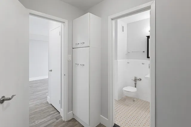 a bathroom with a granite countertop toilet and a sink