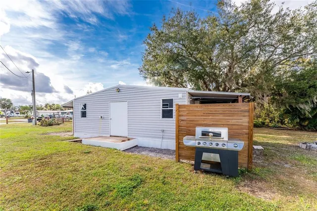 a backyard of a house with table and chairs