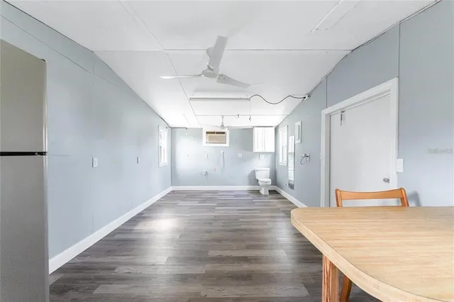 a view of a kitchen with a sink and wooden floor