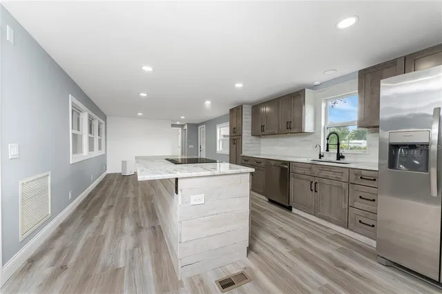 a kitchen with a sink stove and cabinets