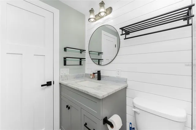 a bathroom with a sink a toilet and a mirror