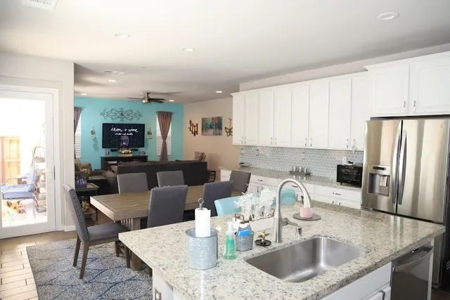a kitchen with kitchen island a white counter top space a sink and appliances