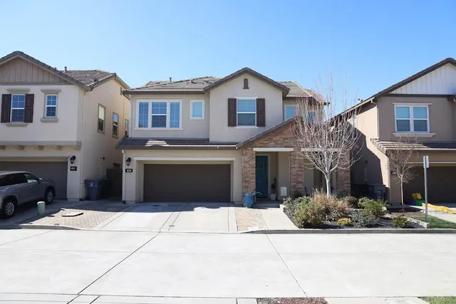 a front view of a house with a yard and garage
