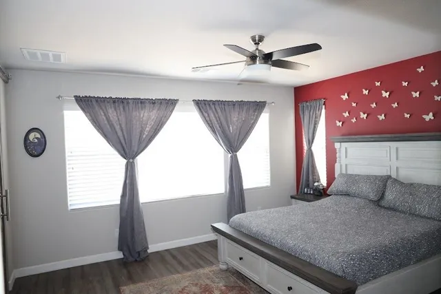 a bedroom with a large bed and a chandelier