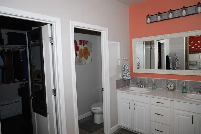 a bathroom with a granite countertop sink toilet and shower