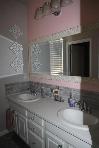 a bathroom with a sink and a mirror
