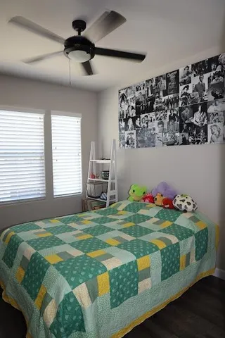 a bedroom with a bed dresser and window