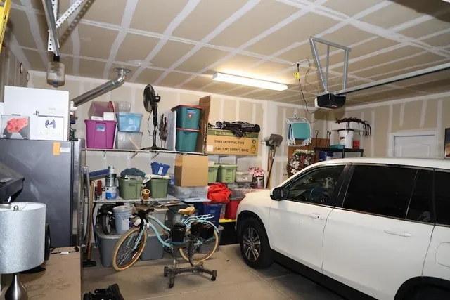 a kitchen that has a lot of cabinets appliances and a sink