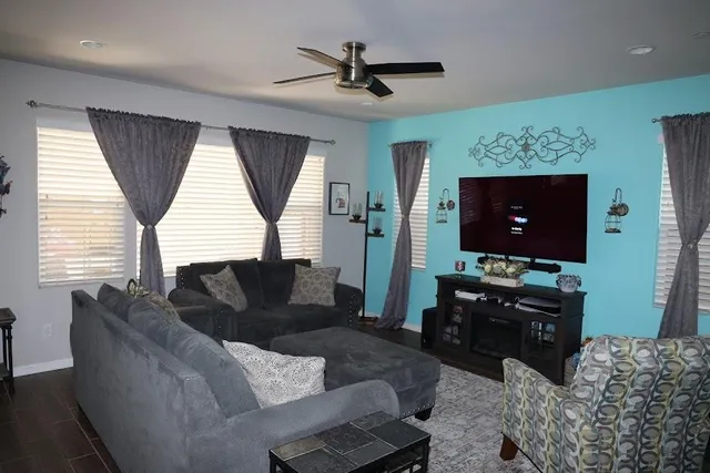 a living room with furniture and a flat screen tv