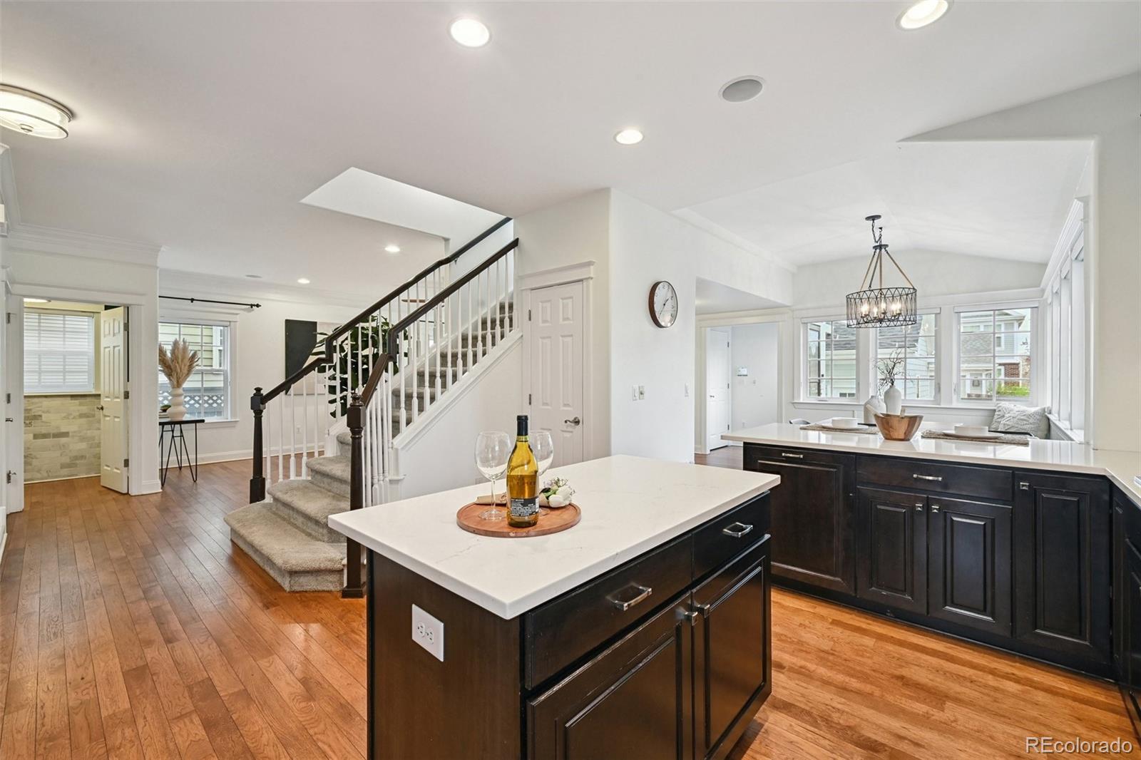 8741 East 33rd Avenue Denver, CO 80238 - Photo 12 of 43 a kitchen with a sink cabinets and wooden floor
