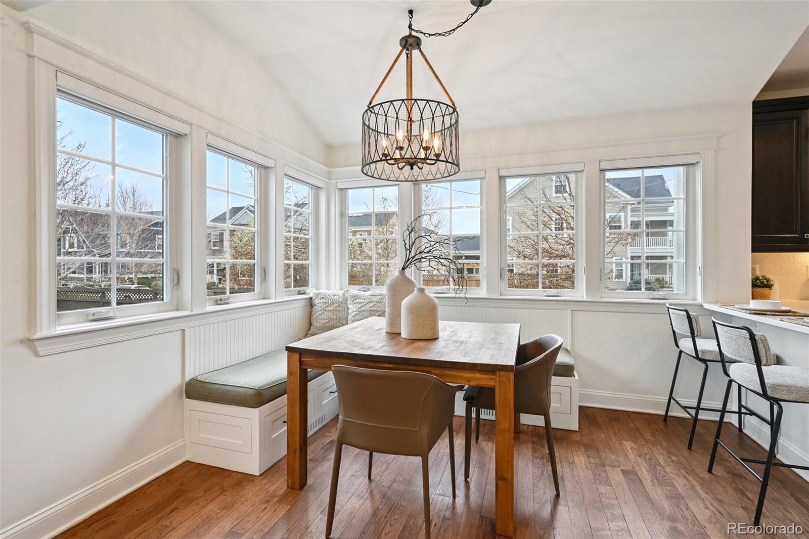 8741 East 33rd Avenue Denver, CO 80238 - Photo 14 of 43 a dining room with furniture a chandelier and wooden floor