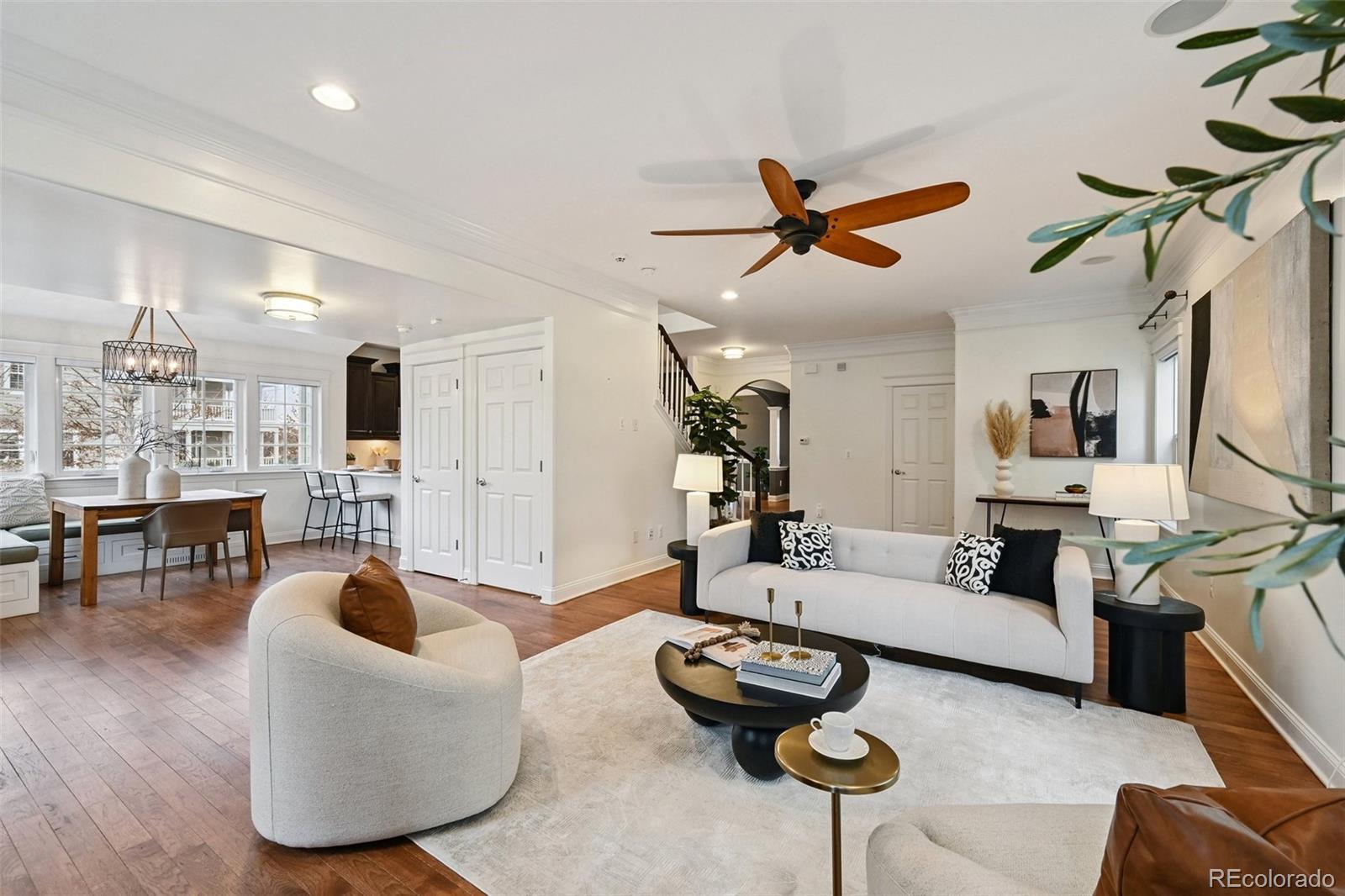 8741 East 33rd Avenue Denver, CO 80238 - Photo 16 of 43 a living room with furniture a rug and a chandelier