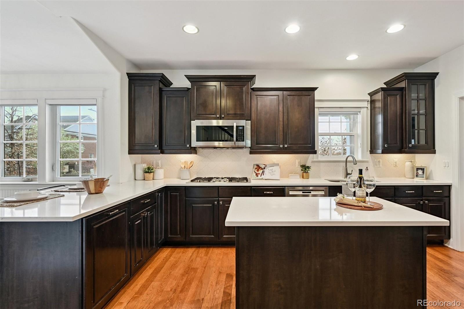 8741 East 33rd Avenue Denver, CO 80238 - Photo 2 of 43 a kitchen with a sink stove and microwave