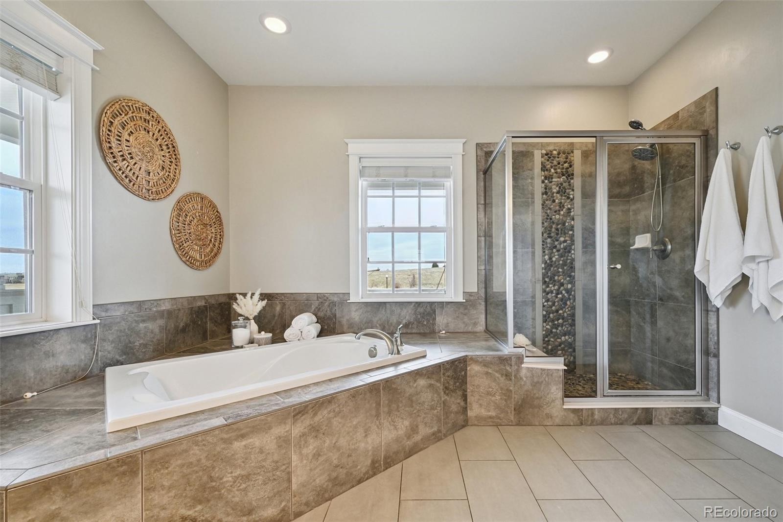 8741 East 33rd Avenue Denver, CO 80238 - Photo 21 of 43 a spacious bathroom with a granite countertop tub sink and mirror